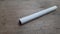 a white cigarette stick on a wooden board