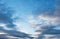 White cirrus, feathery clouds  against spring bright blue cloudy sky  at the sunset in England