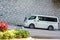 A white classic van parked on the half slope of the street in Hong Kong