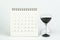 White clean calendar with sandglass or hourglass on white background using as timer or time counting down or business plan with