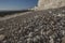 White cliffs, grey pebbles and blue skies - Seven Sisters, East Sussex, England, the UK.