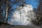 White cloud behind a hill