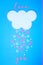 White cloud on blue background with pink and white hearts falling down like snow