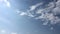 White cloud disappear in the hot sun on blue sky. Cumulus clouds form against a brilliant blue sky. Time-lapse motion clouds blue