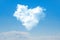 White cloud in the shape of a heart in the blue sky. Natural shape heart in the sky with clouds. Heart shaped cloud over blue sky