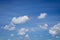 White clouds in blue sky background.