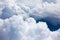 White clouds on blue sky background close up, cumulus clouds high in azure skies, beautiful aerial cloudscape view from above