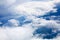 White clouds on blue sky background close up, cumulus clouds high in azure skies, beautiful aerial cloudscape view from above