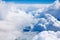 White clouds on blue sky background close up, cumulus clouds high in azure skies, beautiful aerial cloudscape view from above