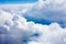 White clouds on blue sky background close up, cumulus clouds high in azure skies, beautiful aerial cloudscape view from above