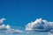 White clouds Cumulus clouds floating on a blue sky for a background concept, a place to copy space, ascension to the Kingdom of