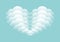 White clouds form a heart on blue background of greeting design for Valentines day or Wedding.