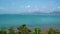 White clouds move in the clear blue sky over sea near Phuket City. Motion Time lapse White clouds swim and change shape.Puffy fluf