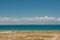 White clouds over artificial lake of the Central Asian. Sunny scene in Kyrgyzstan