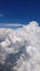 white clouds and raincloud in blue sky view From a plane