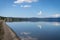 White clouds reflecting in the crystal mirror waters of Lake Bracciano in Lazio, Italy