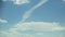 The white clouds in the sky move beautifully and softly, shot with Time Lapse in a tall building. The view is slightly tilted up a