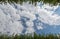 White clouds surrounded by luxuriant trees