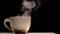 White coffee cup with steam in slow motion on black background