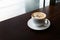 White coffee cup on wooden desk table/nobody