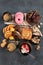 White coffee with delicious cookie, donuts, cake, sugar, waffles. Hot drink with sweets on dark background