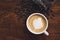 White coffee mug. Coffee is a latte. table on the wooden table in vintage style, taken from the top view, see the froth of milk