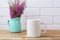 White coffee mug mockup with maroon purple flowers in mint pitch