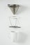 White coffee mug on white background. Metal pour over drip cone pulled apart