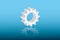 A white cog wheel of a machine vector illustration for machine in business on blue background to mean work speed in industry