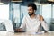 White-collar worker using laptop on desk with water