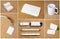 White collection of stationery on corkboard background.