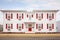 white colonial house, red door, twostory, symmetrical windows