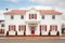 white colonial house, red door, twostory, symmetrical windows