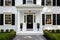 white colonial residence, black central front door with a brass knocker