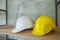 The white color helmet belongs to the engineer and the yellow color belongs to the worker is placed on the rack for the hat keep