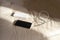 White colored power bank charging black color smart phone.