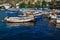 White colorful ships and boats in water at piers among houses and building of town balaclava near  mountains, reflections