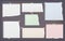 White and colorful torn, lined, and squared note, notebook paper strips for text stuck with sticky tape on dark