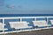 White comfort benches on sea walking pier