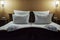 White comfortable pillow on bed decoration interior of hotel bedroom