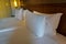 white comfy pillows on double bed in luxury hotel bedroom