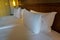 White comfy pillows on double bed in luxury hotel bedroom