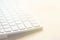 White computer keyboard on wood tabletop. Blurred abstract background for business studying freelance self-employment concept