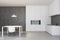 White and concrete kitchen with table