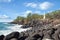 White concrete lighthouse on rocky Hawaii shore