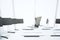 White conference table with laptop and accessories