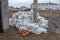 White construction sacks of construction waste are dumped in heap near fence under construction. Pollution concept. Ppile of