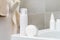 White containers with cosmetics in the bathroom with gray walls. Spa. Body care