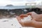 White coral scraps who look like popcorn holds by hands in Playa de Majanicho, Fuerteventura, Spain