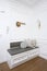 White corner nook with gray cushions in an apartment entryway